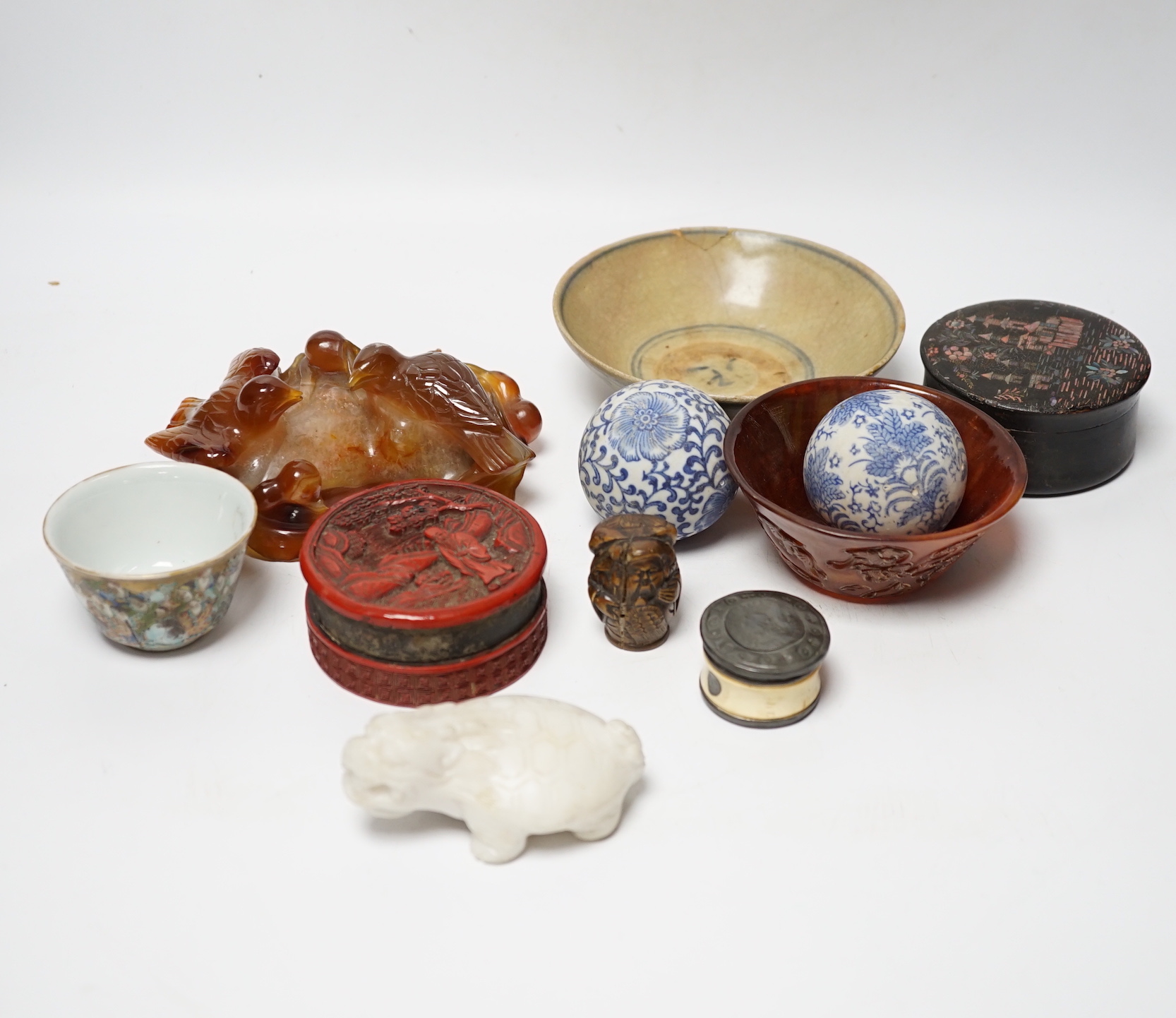 Eleven Chinese or Japanese items including; a bowl, a red lacquer box, an agate carving of a bird group, a carved hardstone lion tortoise, mother of pearl counters, etc.